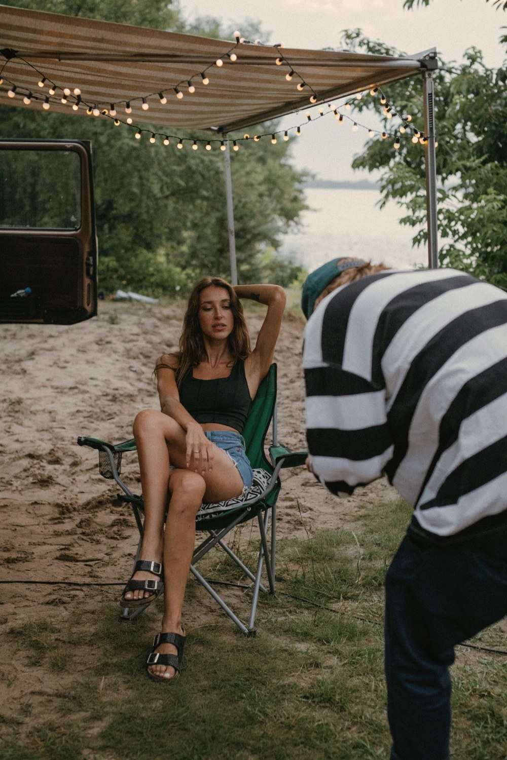 Imperium creator BTS — chair, photographer, awning, lake